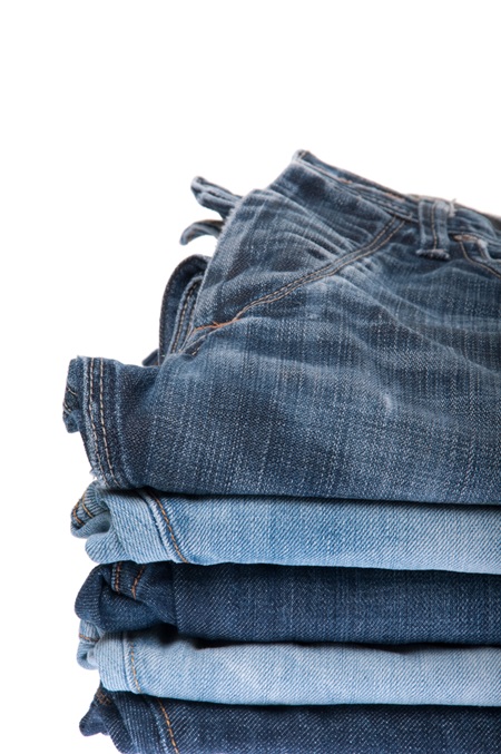 stack of blue jeans isolated on white background