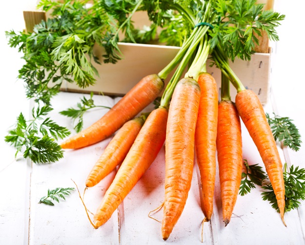 fresh carrots on wooden table