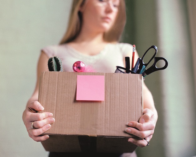 Woman carrying box of stationery --- Image by © Image Source/Corbis