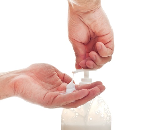 washing hands with liquid soap, white background