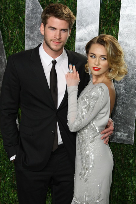 Miley Cyrus, right, and boyfriend Liam Hemsworth arrive at the 2012 Vanity Fair Oscar Party held at the Sunset Tower Hotel in West Hollywood, California on February 26, 2012. (Chaz Niell/Elevation Photos/Abaca Press/MCT) Photo via Newscom
