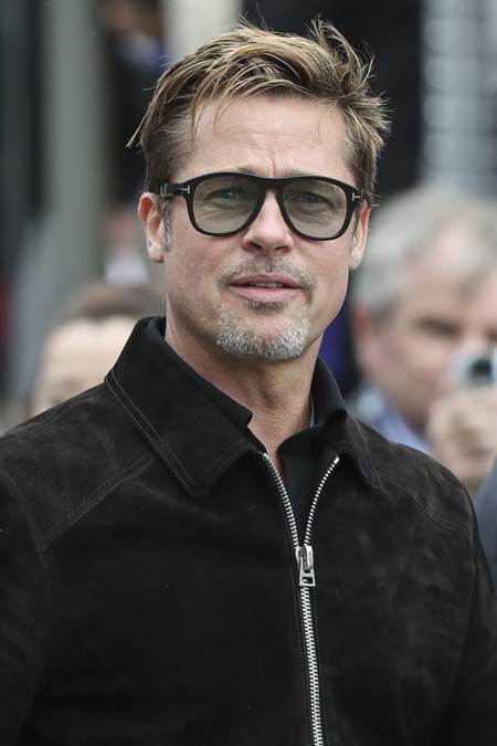 Actor Brad Pitt poses for photographs, prior the 84th 24-hour Le Mans endurance race, in Le Mans, western France, Saturday, June 18, 2016. (AP Photo/Kamil Zihnioglu)