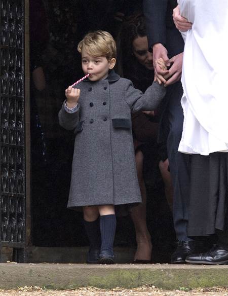 Mandatory Credit: Photo by REX/Shutterstock (7666247g) Prince George after the service with a candy cane sweet Christmas Day church service, Englefield, UK - 25 Dec 2016